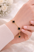 Four clover charm bracelet in gold tone black enamel - dorie jewelry